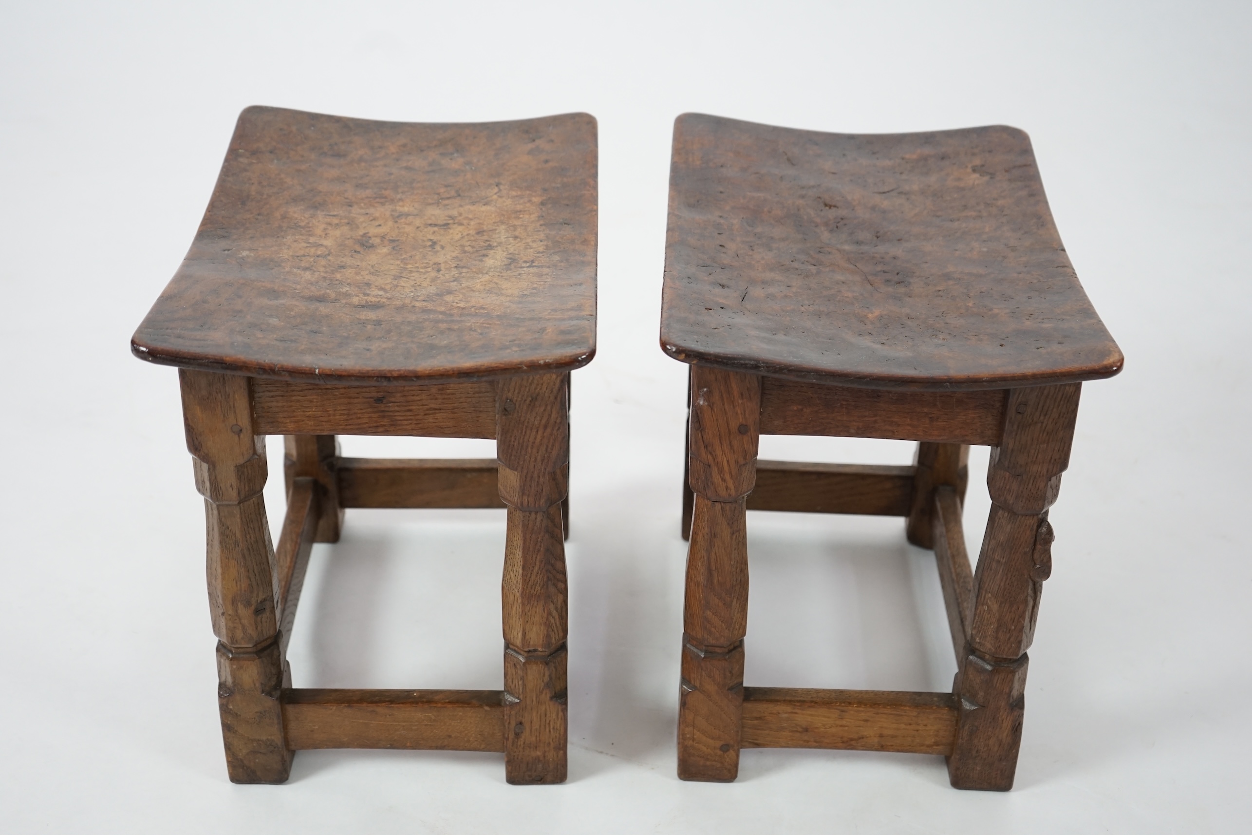 A pair of Robert 'Mouseman' Thompson burr oak stools, 1930s